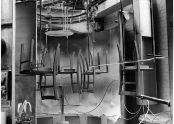 View of chairs suspended on a conveyor system, 5 Aug 1958